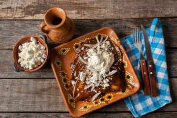 Mexican mole sauce enchiladas with cheese and sesame seeds