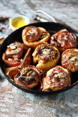 Baked apples in a pan with cinnamon, honey and spices. Healthy autumn dessert. The diet is friendly. Vegan Dessert. Selective focus. Macro.