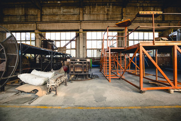 Rusty mechanisms and tools in the shop of an old abandoned factory.