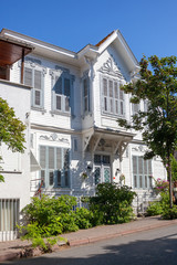 Beautiful house with shutters from white boards