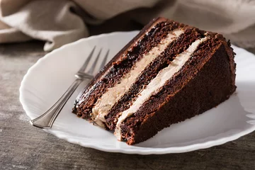 Foto op Plexiglas Chocolate cake slice on wooden table © chandlervid85