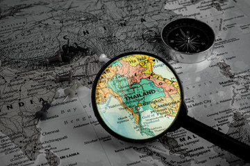 magnifying glass selective focus at Thailand map. - economic and business concept.
