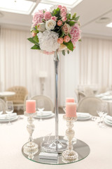 Close-up stand for a candlestick and a table number in a restaurant. Event decor