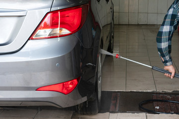 Gray car wash with water at a car wash. Contactless sink. Car wash. Self-service car wash