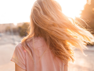 Young woman with golden hair. Back