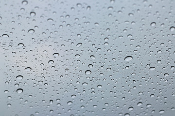Pattern of water rain drops on window background