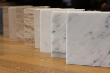 color samples of marble  on oak wood table, material for interior designer