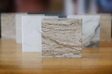 color samples of marble  on oak wood table, material for interior designer