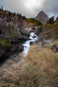 Long exposure of Mountain, Swiftcurrent falls and the grass moving because of the wind, Montana.