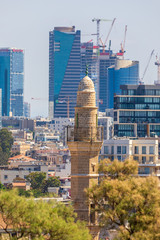 The minaret of Mahmoudiya Mosque on modern buildings background
