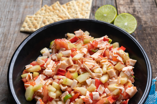 Surimi Crab Ceviche With Cucumber And Tomato On Wooden Background