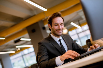 Young businessman working on computer at office