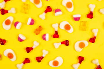 Assorted jelly sweets on yellow background. Pattern.