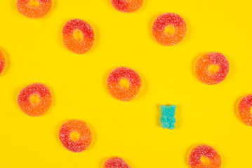 Jelly sweets rings on yellow background. Pattern.