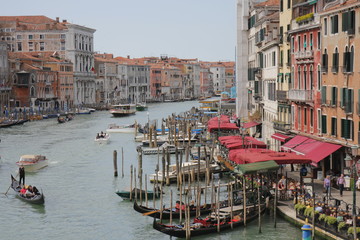 Fototapeta na wymiar View from Realto Island, Venice - canals, boats, buildings and numerous indoor cafes along the coast