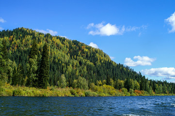 the river flows along the mountain