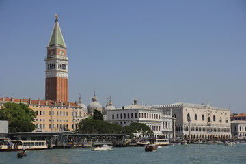 Venice's Grand Canal, buildings, tower. River trams sail along the canal (vaporetto)