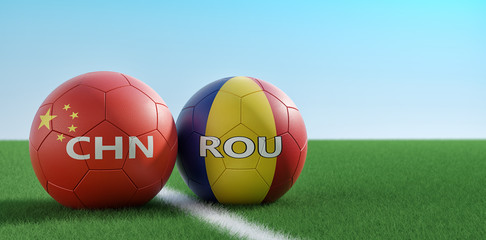 Romania vs. China Soccer Match - Soccer balls in China and Romania national colors on a soccer field. Copy space on the right side - 3D Rendering