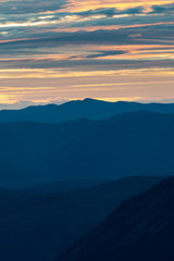 The set of mountains in the distance as seen from the Hidden Lake overlook on sunset, Glacier Park, Montana.