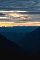 The set of mountains in the distance as seen from the Hidden Lake overlook on sunset, Glacier Park, Montana.