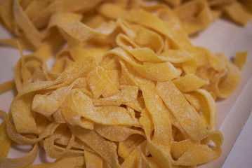 Raw tagliatelle pasta on a tray