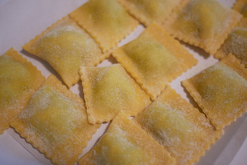 Raw ravioli pasta on a tray