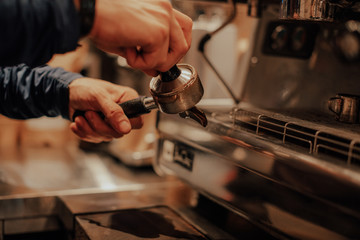 Barista make coffee latte art with espresso machine in cafe vintage instagram filter. Barista male...
