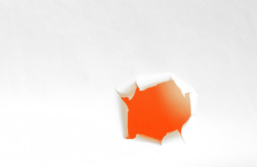 Orange Hole of torn white paper. Copy space