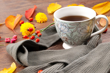 Autumn tea mug wrapped in a warm scarf