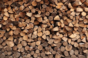 round and triangular firewood neatly stacked