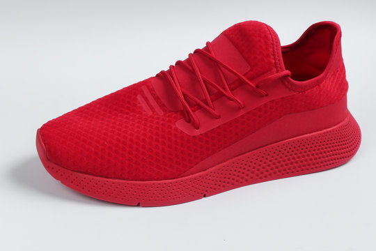 One stylish red sports shoes for running on white background. Top view
