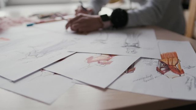 designer of clothes makes an outline of clothes with a felt-tip pen