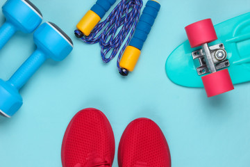 Minimalistic sport still life. Sports outfit. Red sports shoes for training and dumbbells, jump...