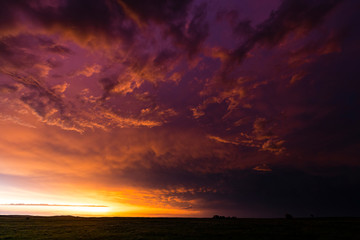 Dramatic orange and purple colours as the sun sets after a large storm