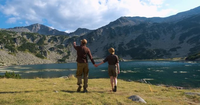 Couple of travelers walk and having fun in the bulgarian mountains, summer time hiking 