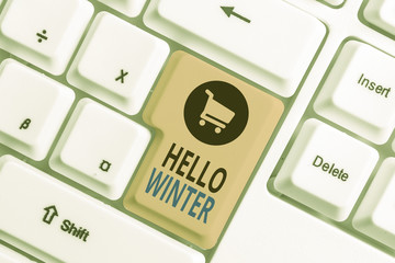 Word writing text Hello Winter. Business photo showcasing coldest season of the year in polar and temperate zones White pc keyboard with empty note paper above white background key copy space