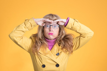 scared adult woman with autumn fashion on color background