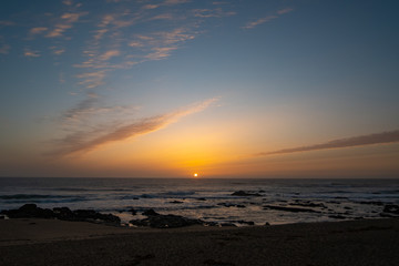 Sun on horizon at sunset on beach in Portugal. Early autumn.