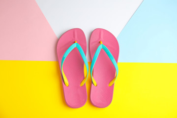Flat lay composition with flip flops on color background. Beach objects