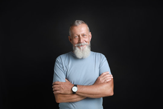 Portrait of handsome senior man on black background