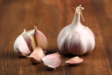 Garlic bulbs and cloves on wooden table