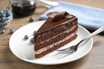 Delicious fresh chocolate cake served on wooden table