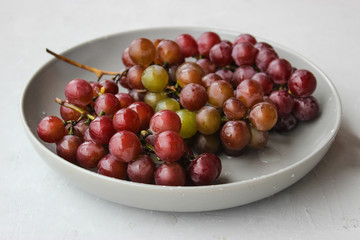 grapes on a plate with water droplets