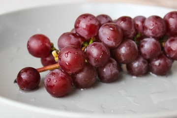 grapes on a plate with water droplets