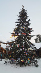 Christmas tree decorated with many country flags at Santa Claus Village in Rovaniemi. Arctic circle, Lapland, Finland