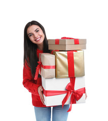 Happy young woman holding Christmas gifts on white background