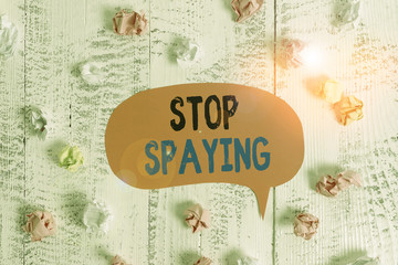 Conceptual hand writing showing Stop Spaying. Concept meaning quit in secretly obtain information on an enemy or competitor Colored speech bubble paper balls wooden rustic vintage background
