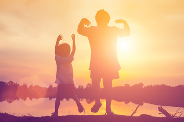 Fototapeta premium kid silhouette,Moments of the child's joy. On the Nature sunset