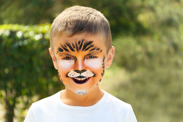 Cute little boy with face painting outdoors © New Africa