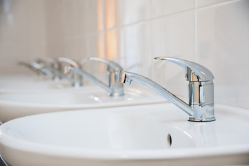 Close-up of row modern ceramic wash hand basins